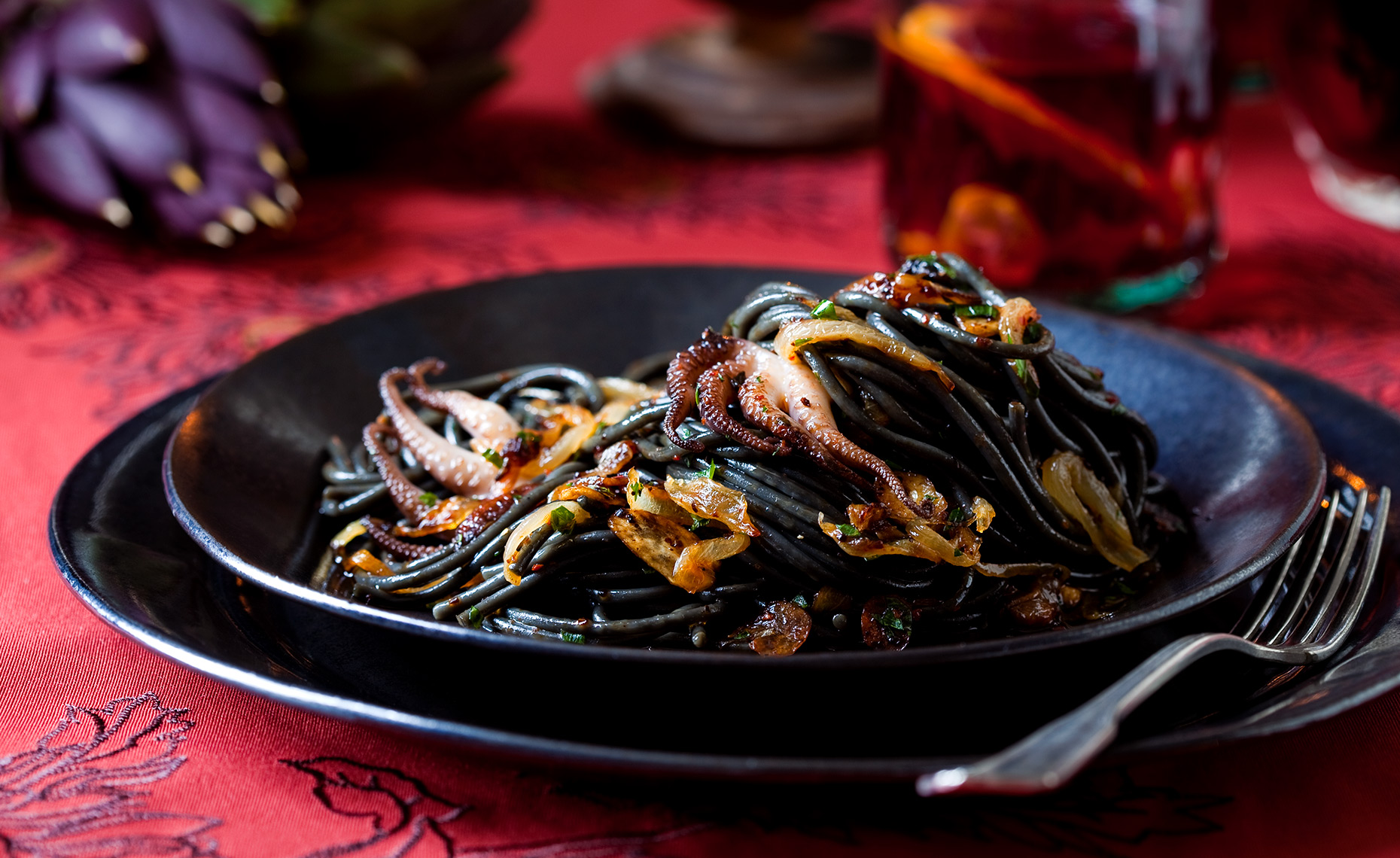 Squid ink pasta with octopus and spicy tomato sauce