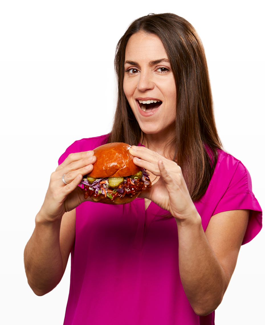 Woman enjoying a pulled pork sandwich