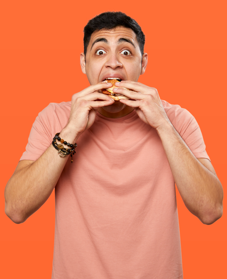 Hispanic man enjoying a breakfast sandwich